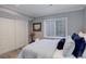 Bedroom with neutral tones, a large window, and closet space at 8338 E 148Th Way, Thornton, CO 80602