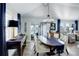 Dining area features a dark wood table, elegant decor, and seamless flow into the adjacent living space at 8338 E 148Th Way, Thornton, CO 80602