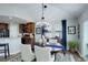 Dining area and kitchen with modern lighting, elegant chairs, and views of the exterior at 8338 E 148Th Way, Thornton, CO 80602