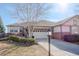 Charming single-Gathering home with a well-maintained lawn, mature trees, and a two-car garage at 8338 E 148Th Way, Thornton, CO 80602