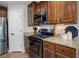 Stylish kitchen boasts stainless steel appliances, granite countertops, and wood cabinets with glass fronts at 8338 E 148Th Way, Thornton, CO 80602
