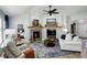 Open-concept living room with a fireplace, neutral tones, and seamless access to other parts of the home at 8338 E 148Th Way, Thornton, CO 80602