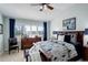 Elegant main bedroom with beautiful bed, furniture, curtains, and lots of windows at 8338 E 148Th Way, Thornton, CO 80602