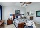 Comfortable main bedroom with king bed, lamps, and furniture. The ensuite is shown in the background at 8338 E 148Th Way, Thornton, CO 80602