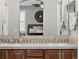 The primary bathroom has double sinks, beautiful tile counters, and a view of the bedroom at 681 W Burgundy St # A, Highlands Ranch, CO 80129