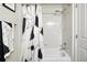 This bathroom features a tub with a shower head and a modern shower curtain at 681 W Burgundy St # A, Highlands Ranch, CO 80129