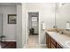 This bathroom features double sinks, a bathtub with blinds, and tile flooring at 681 W Burgundy St # A, Highlands Ranch, CO 80129