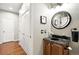 A powder room features modern lighting, granite counters, and wood floors at 681 W Burgundy St # A, Highlands Ranch, CO 80129