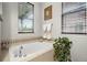The bathtub area offers large windows, beautiful tile, and is great for relaxing at 681 W Burgundy St # A, Highlands Ranch, CO 80129
