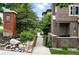 Attractive two-story townhome featuring brick exterior, manicured landscaping, and welcoming front entrance at 681 W Burgundy St # A, Highlands Ranch, CO 80129