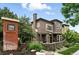 Attractive two-story townhome featuring brick exterior, manicured landscaping, and welcoming front entrance at 681 W Burgundy St # A, Highlands Ranch, CO 80129