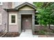 Inviting front entrance with brick facade, covered porch, and decorative wreath on the front door at 681 W Burgundy St # A, Highlands Ranch, CO 80129