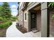 Inviting front entrance with brick facade, covered porch, and decorative wreath on the front door at 681 W Burgundy St # A, Highlands Ranch, CO 80129