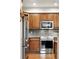Modern kitchen with stainless steel appliances, light wood cabinets, and stone countertops at 681 W Burgundy St # A, Highlands Ranch, CO 80129