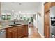 A kitchen bar overlooks the dining room in this home with wood floors and natural light at 681 W Burgundy St # A, Highlands Ranch, CO 80129