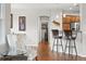 View of the kitchen with bar seating, hardwood floors, stainless steel appliances, and neutral paint at 681 W Burgundy St # A, Highlands Ranch, CO 80129