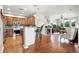 Open concept floorplan with kitchen, bar seating, and living room with fireplace and hardwood floors at 681 W Burgundy St # A, Highlands Ranch, CO 80129