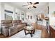 Bright living room features hardwood floors, fireplace, ceiling fan, and large windows for natural light at 681 W Burgundy St # A, Highlands Ranch, CO 80129