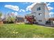 Large backyard with a deck and stairs, green grass, and a swing set, perfect for Gathering activities at 3543 S Ceylon Way, Aurora, CO 80013