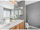 Bathroom with double sinks, and a large mirror above the vanity at 3543 S Ceylon Way, Aurora, CO 80013