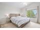 Bright bedroom with a large window, a ceiling fan, and a wood-frame bed at 3543 S Ceylon Way, Aurora, CO 80013
