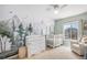 Bedroom featuring a crib, dresser, and a forest mural wall at 3543 S Ceylon Way, Aurora, CO 80013