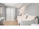 Bedroom with a daybed, a desk, and a double door closet with gray walls at 3543 S Ceylon Way, Aurora, CO 80013