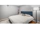 Bedroom with a blue headboard, and a decorative rug on the hardwood floors at 3543 S Ceylon Way, Aurora, CO 80013