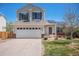 Charming two-story home with a well-manicured lawn, solar panels, and an attached two-car garage at 3543 S Ceylon Way, Aurora, CO 80013
