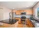 Modern kitchen with stainless steel appliances, sleek countertops, and ample cabinet space, perfect for cooking at 3543 S Ceylon Way, Aurora, CO 80013