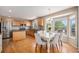Eat-in kitchen featuring stainless steel appliances, wood cabinets, granite counters and an island with breakfast bar at 3543 S Ceylon Way, Aurora, CO 80013
