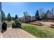 Well-maintained backyard with a stone patio, vibrant green grass, and mature trees, perfect for outdoor enjoyment at 7087 Sapphire Pointe Blvd, Castle Rock, CO 80108