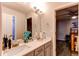 Bathroom with double sinks and view to bedroom with ceiling fan at 7087 Sapphire Pointe Blvd, Castle Rock, CO 80108