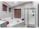 Well-lit bathroom featuring a soaking tub, a separate shower, and modern fixtures at 7087 Sapphire Pointe Blvd, Castle Rock, CO 80108