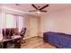 Bedroom with wood floors, ceiling fan, a door, and desk at 7087 Sapphire Pointe Blvd, Castle Rock, CO 80108