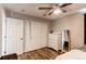 Bedroom with wood floors, a ceiling fan, closet with sliding doors and a dresser at 7087 Sapphire Pointe Blvd, Castle Rock, CO 80108