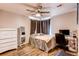 Comfortable bedroom with wood floors, ceiling fan, and natural light from the window at 7087 Sapphire Pointe Blvd, Castle Rock, CO 80108