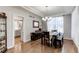 Traditional dining room featuring hardwood floors and decorative lighting fixtures at 7087 Sapphire Pointe Blvd, Castle Rock, CO 80108