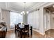 Elegant dining room with a modern chandelier and natural light at 7087 Sapphire Pointe Blvd, Castle Rock, CO 80108