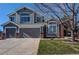 Charming gray two-story home with a well-manicured lawn, two-car garage, and appealing curb appeal at 7087 Sapphire Pointe Blvd, Castle Rock, CO 80108