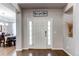 Inviting foyer with hardwood floors, leading to the dining area with natural light and a transom window at 7087 Sapphire Pointe Blvd, Castle Rock, CO 80108