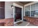 Elegant front door with glass panels, complemented by brick accents and a 'Welcome' mat at 7087 Sapphire Pointe Blvd, Castle Rock, CO 80108