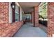Inviting covered front porch with brick columns, offering a cozy outdoor seating area at 7087 Sapphire Pointe Blvd, Castle Rock, CO 80108