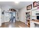 Bright home office with french doors, hardwood floors, a white bookcase, and desk space at 7087 Sapphire Pointe Blvd, Castle Rock, CO 80108
