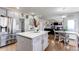 Open-concept kitchen with island, stainless steel appliances, and seamless flow to living spaces at 7087 Sapphire Pointe Blvd, Castle Rock, CO 80108
