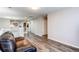 Open living area with wood floors, leather chair, white railing, and neutral walls at 7087 Sapphire Pointe Blvd, Castle Rock, CO 80108