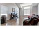 Bright living room with large windows, hardwood floors, and a cozy seating area, perfect for relaxation at 7087 Sapphire Pointe Blvd, Castle Rock, CO 80108