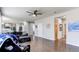 Open living room with hardwood floors, modern ceiling fan, and seamless flow to the kitchen at 7087 Sapphire Pointe Blvd, Castle Rock, CO 80108