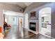 Spacious living room featuring a fireplace, archways, and tile flooring that leads to a bathroom at 7087 Sapphire Pointe Blvd, Castle Rock, CO 80108