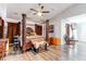 A four-poster bed centers a bright bedroom with light colored plank flooring and modern ceiling fan at 7087 Sapphire Pointe Blvd, Castle Rock, CO 80108